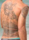 man with back snake tattoo